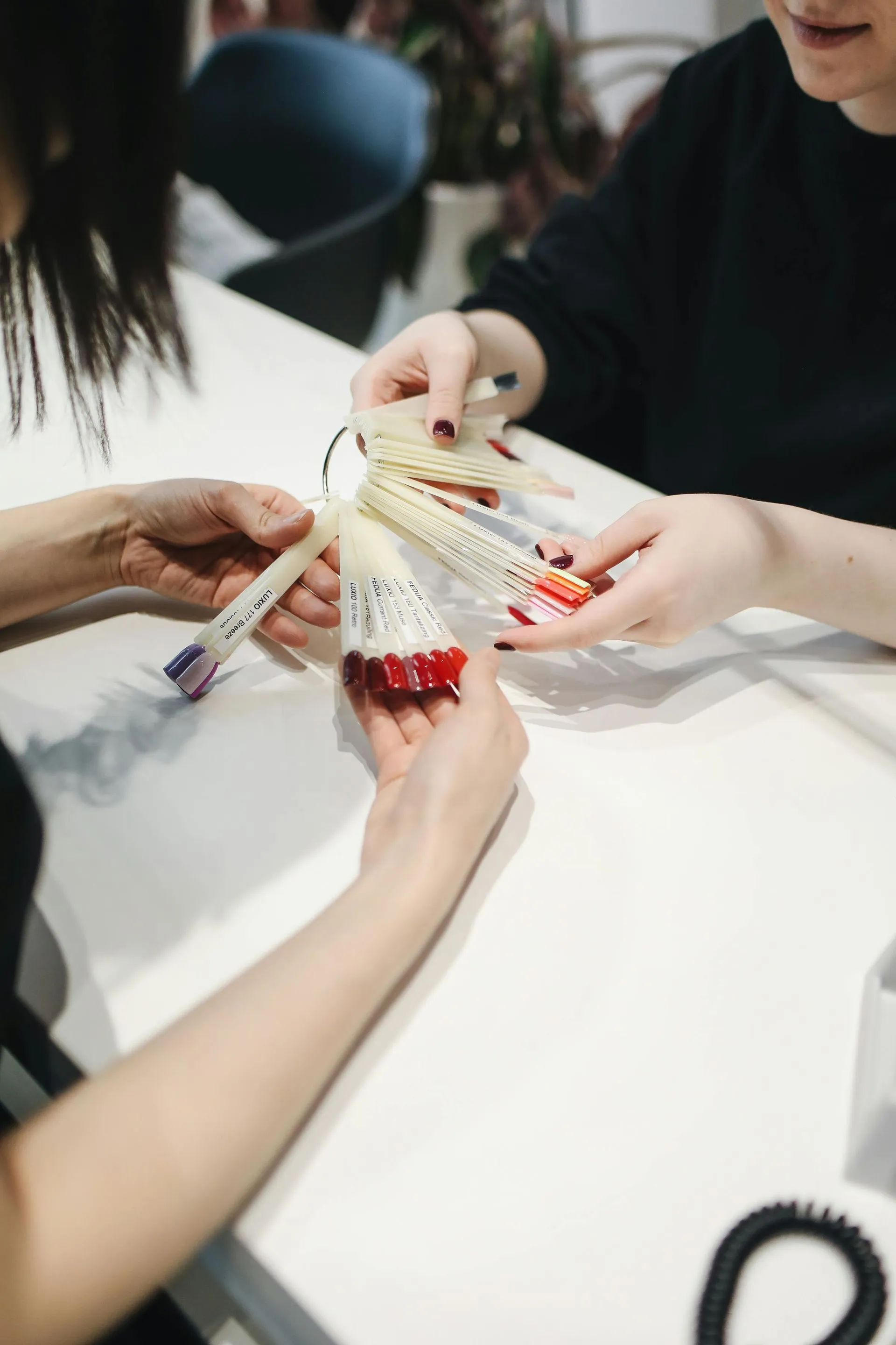 Clients selecting nail colors at Alura Beaute